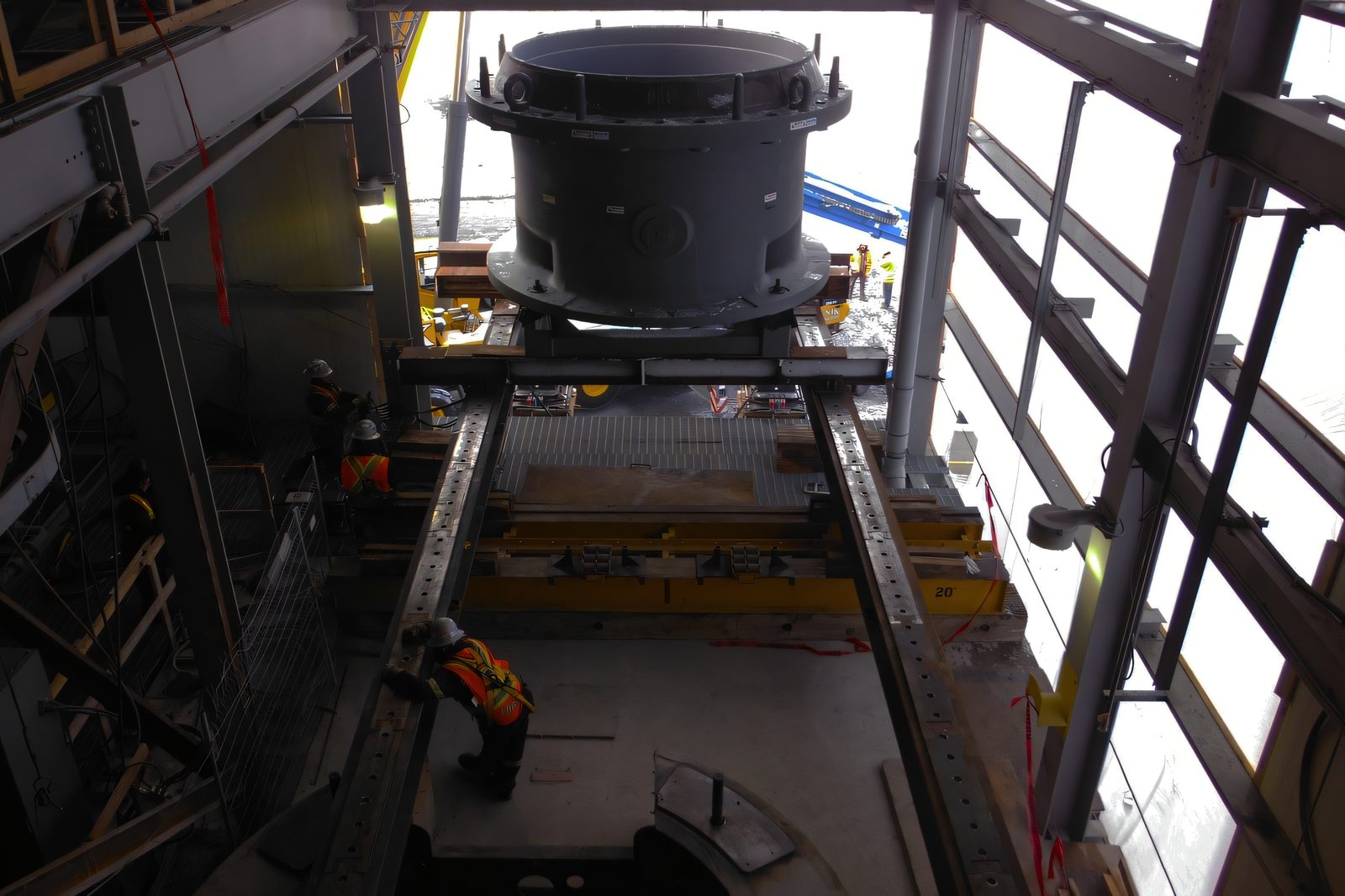 Le système de levage et de glissage hydraulique sous une pièce cylindrique, à l’intérieur d’un bâtiment industriel